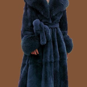 May include: A long, navy blue faux fur coat with a large collar and cuffs. The coat features a matching belt and is designed to be floor-length. The plush texture and deep colour create a luxurious look. The coat's measurements are approximately 152 cm in length.