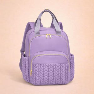 purple diaper backpack on beige background, stylish baby diaper bag