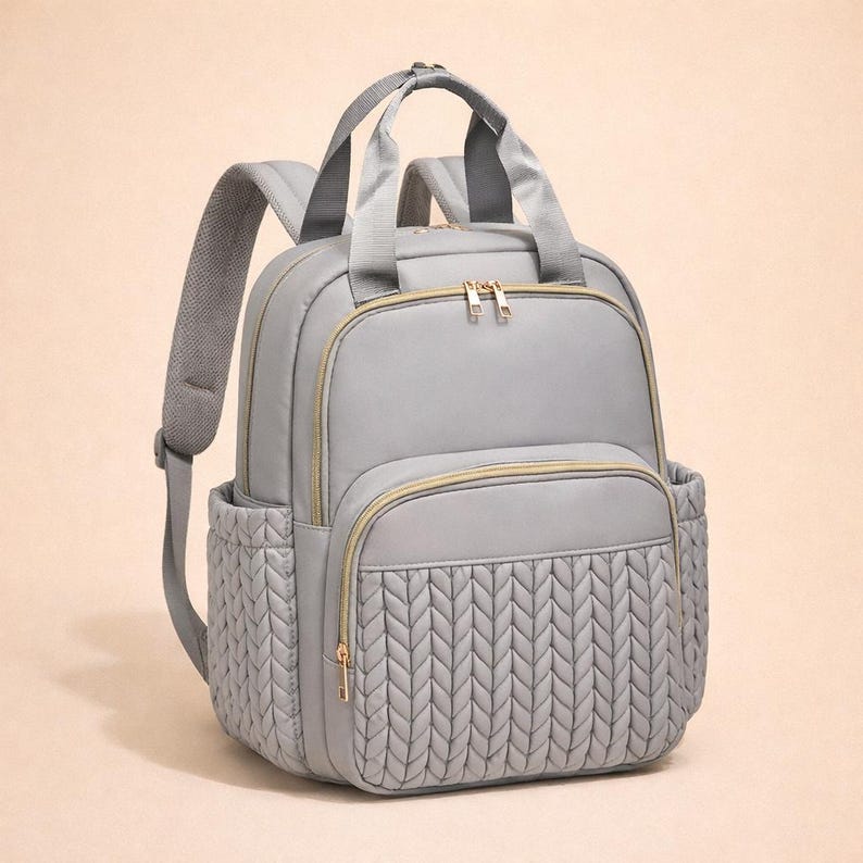 Gray diaper backpack on beige background, minimalist baby bag product photo