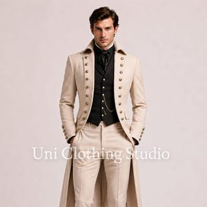 May include: A beige long coat with two rows of metallic buttons, worn over a black waistcoat and black shirt with a cravat. The outfit includes matching beige trousers and black dress shoes. The text Uni Clothing Studio is visible.