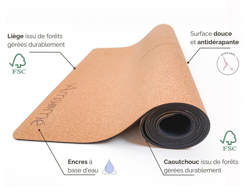 May include: A rolled yoga mat made from cork and rubber. The mat is light brown with the brand name "Amsm&eacute;" printed on it. The text on the mat indicates it is made from sustainably managed forests and has a soft, non-slip surface.