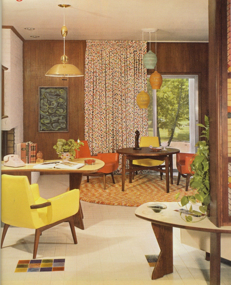 May include: A mid-century modern living room with yellow and orange furniture. The room features a round dining table, armchairs, a desk, and a patterned rug. Decorative pendant lights and a colorful curtain add to the retro aesthetic.