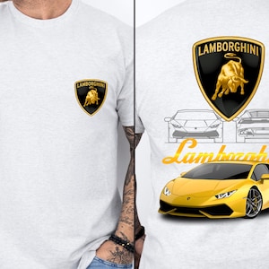 May include: Light grey t-shirt with the Lamborghini logo on the front and back. The back design features the Lamborghini emblem, car outlines, the word "Lamborghini" in yellow script, and a yellow sports car illustration.