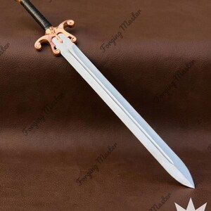 May include: A double-edged sword with a polished silver-toned steel blade, a black wrapped grip, and a copper-toned metal crossguard and pommel. The blade features a central fuller running down its length. The text Forging Master is visible.