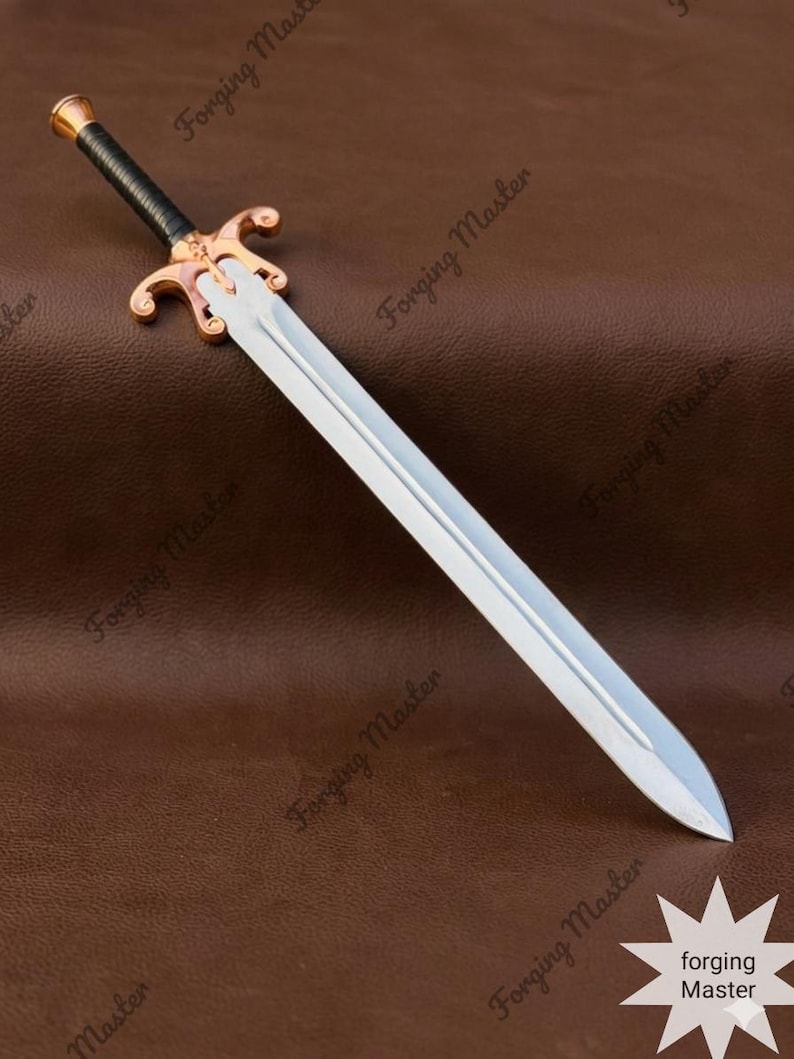 May include: A double-edged sword with a polished silver-toned steel blade, a black wrapped grip, and a copper-toned metal crossguard and pommel. The blade features a central fuller running down its length. The text Forging Master is visible.