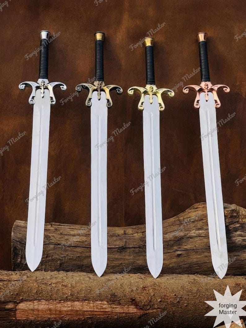 May include: Four swords with silver-toned blades and black wrapped handles. Each sword features a distinct metal crossguard in silver, dark bronze, gold, and copper tones, with a small skull emblem at the center of each guard and the text Forging Master.