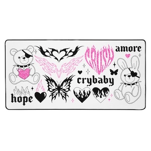 May include: White rectangular mousepad with black and pink graphics. Designs include a teddy bear with an eye patch, hearts, butterflies, flames, and the words "crush", "crybaby", "amore", and "hope".