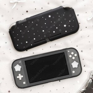 May include: Black Nintendo Switch Lite case with a white star pattern. The case is shown with the console, which has a black screen and gray buttons. The case is designed to protect the console from scratches and damage.
