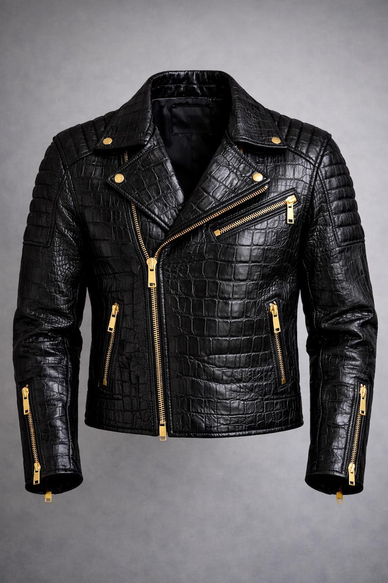 May include: Black leather jacket with a crocodile skin texture. The jacket features a classic biker style with a notched collar, quilted shoulders, and multiple zippered pockets. Gold-colored zippers and hardware provide contrast.