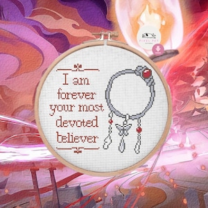 May include: A cross-stitch embroidery hoop with the text "I am forever your most devoted believer" in red thread. A silver-colored charm with a red gem and dangling charms is stitched on the fabric. The background is a colorful, stylized illustration.