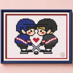 May include: A cross-stitch pattern in a dark blue, white, and red frame featuring two hockey players in blue and black jerseys facing each other. Between them is a white shield with a red heart and two crossed hockey sticks at the bottom.
