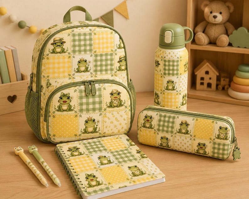 May include: A backpack, a water bottle, a pencil case, and a spiral notebook, all featuring a matching yellow and green checkered pattern with illustrations of frogs. Two pens with frog toppers are placed next to the notebook.