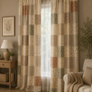 May include: A pair of floor-length curtains featuring a patchwork design with alternating squares in muted tones of beige, sage green, and dusty rose. The fabric displays various patterns including small floral prints, vertical stripes, and solid textures.