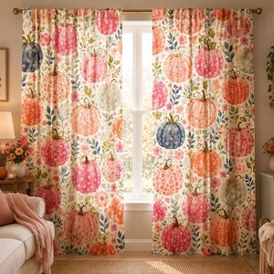 May include: A pair of floor-length window curtains featuring an all-over print of pumpkins in shades of pink, orange, and blue, interspersed with small floral motifs and green foliage on a cream-colored background, hanging from a metal rod.