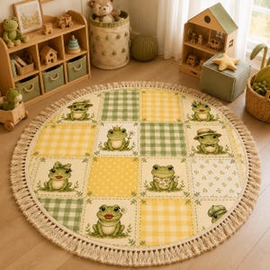 May include: A round area rug featuring a grid pattern of alternating yellow and green squares. The squares display illustrations of frogs with various accessories like hats, crowns, and bows, surrounded by a thick, beige fringe border.