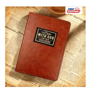 May include: A rectangular brown book with a smooth, leather-like cover. Centered on the front is a black rectangular label with a white border containing the text: One Minute WITH GOD FOR MEN 365 DAILY DEVOTIONS in white lettering.