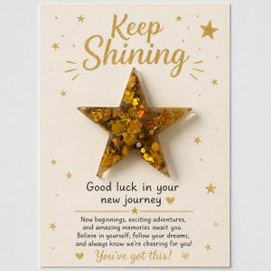 May include: A greeting card with a gold star and the words "Keep Shining" in gold script. The card also includes the message "Good luck in your new journey" and "You've got this!"