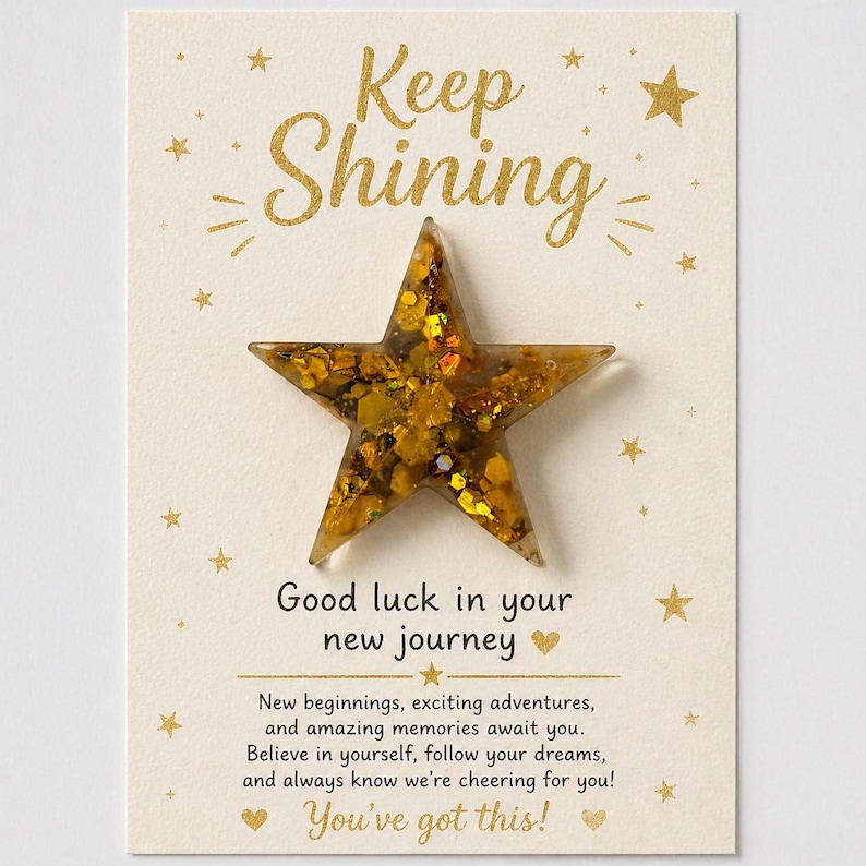 May include: A greeting card with a gold star and the words "Keep Shining" in gold script. The card also includes the message "Good luck in your new journey" and "You've got this!"