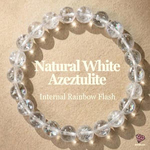 May include: A clear quartz bracelet with the text "Natural White Azeztulite" and "Internal Rainbow Flash". The bracelet is made of round, translucent beads with internal rainbow flashes, strung together on a clear elastic cord.