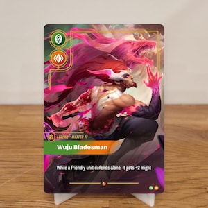 May include: A trading card with a fantasy illustration of a warrior with red hair and a white mask. The card reads "Wuju Bladesman" and features a pink and purple dragon-like creature in the background.