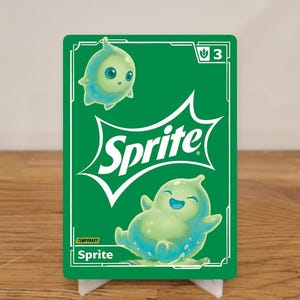 May include: A green and white Sprite-themed card with two cartoon characters. The card features the Sprite logo and the word "TEMPORARY". The background is a wooden surface.