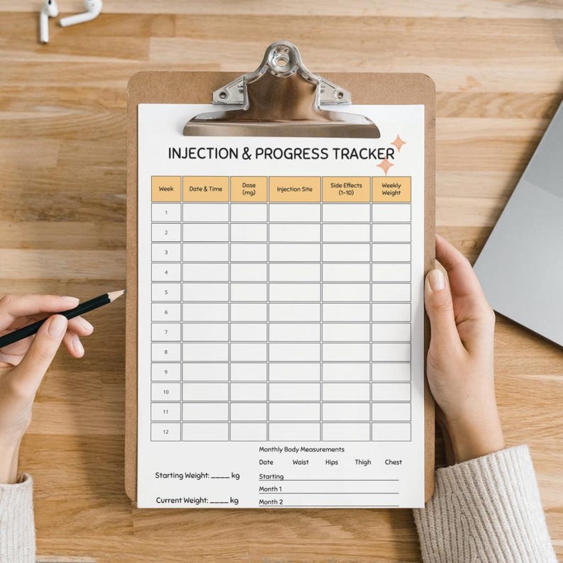 May include: A clipboard with an "INJECTION & PROGRESS TRACKER" form. The form has sections for date, dose, injection site, side effects, and weekly weight. The form also includes a section for monthly body measurements. A pencil is held near the form.