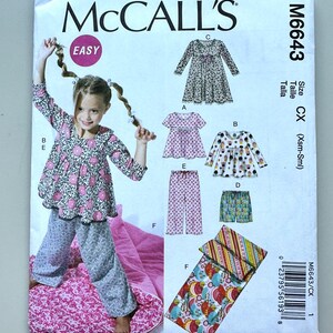 May include: McCall's sewing pattern M6643 for children's sleepwear. The pattern includes options for a top, shorts, pants, and a sleeping bag. The cover features a girl wearing a floral top and pants. Size CX (Xsm-Sml).