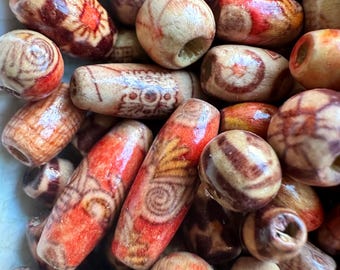 May include: Close-up of a collection of wooden beads in various shapes and sizes. The beads feature natural wood tones with reddish-brown and cream-colored patterns. Some beads have decorative designs.