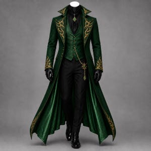 May include: A long dark green coat with gold embroidery on the lapels and cuffs, worn over a matching green vest with gold buttons, a black shirt, black trousers, and black gloves. A gold chain hangs from the vest, and a green brooch is at the neck.