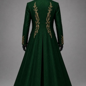 May include: A long, dark green coat featuring a high collar and a flared skirt. The back of the garment is adorned with intricate gold embroidery in a scrolling vine pattern. The sleeves also feature matching gold embroidery at the cuffs.