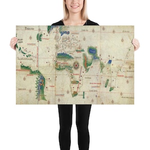 May include: A vintage world map print, featuring detailed cartography with hand-drawn illustrations and text. The map showcases continents and oceans in muted tones, with red and blue accents. The print is held by a person.