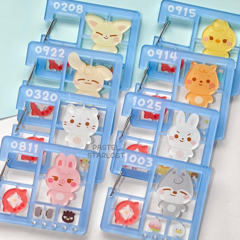 May include: Several light blue acrylic organizers, each with a different cartoon animal character. The organizers have a grid design with numbers and small decorative elements. The text "PASTEL STARLOST" is visible on some.