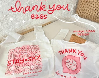May include: Two white reusable shopping bags with red text. One bag says "STAY x SKZ" multiple times with cartoon animal illustrations and "HAVE A CHILL DAY". The other says "THANK YOU" and "have a chill day".