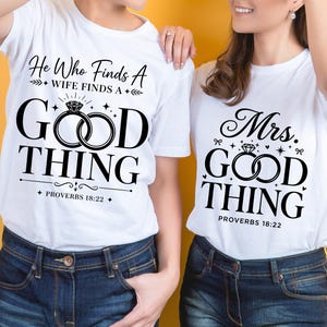 May include: Two white t-shirts featuring black graphic text and ring illustrations. The left shirt reads He Who Finds A WIFE FINDS A GOOD THING PROVERBS 18:22. The right shirt reads Mrs. GOOD THING PROVERBS 18:22. Both shirts are paired with blue jeans.