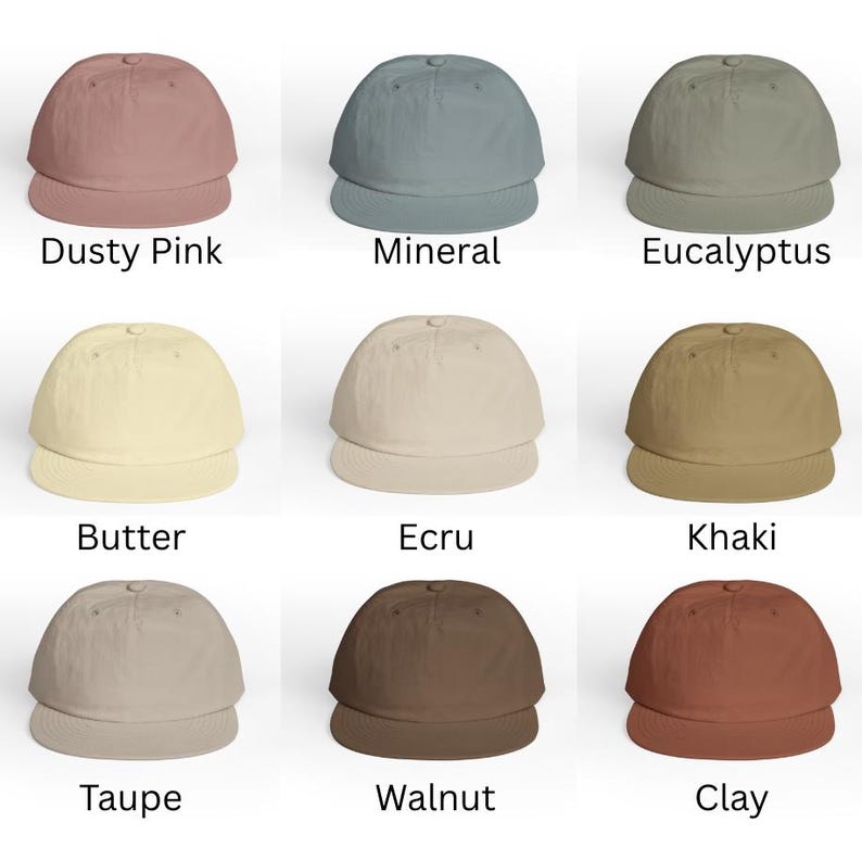 May include: Nine baseball caps in various colors, including dusty pink, mineral, eucalyptus, butter, ecru, khaki, taupe, walnut, and clay. Each cap has a curved brim and a rounded crown. The names of the colors are printed below each cap.
