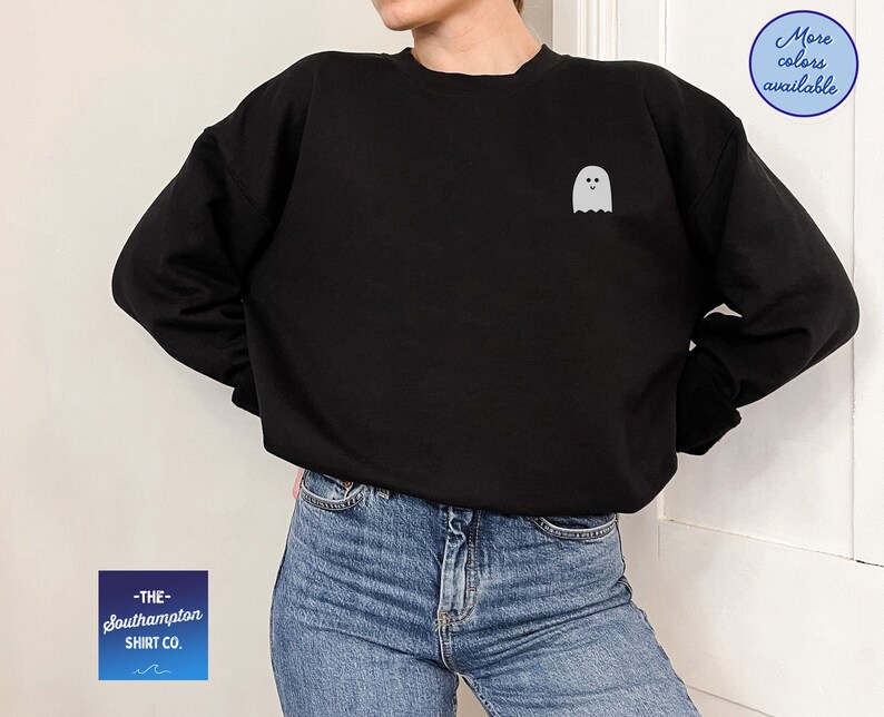 May include: Black sweatshirt with a white ghost graphic on the front. The text "THE southampton SHIRT CO." is on a blue and white gradient background.