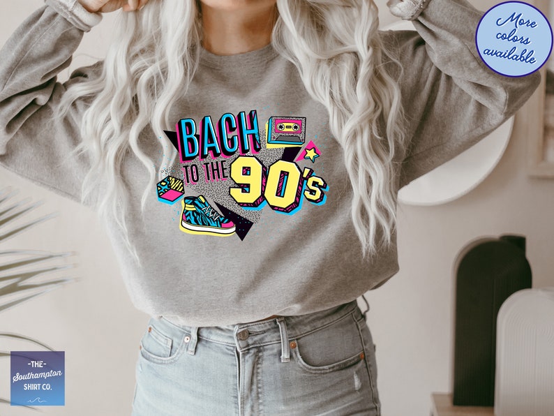 May include: A gray sweatshirt with a graphic print that says "Back to the 90's" in colorful, retro-style lettering. The graphic also includes a cassette tape, a star, and a sneaker.