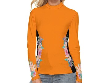 May include: A long-sleeved shirt with a mock neck and floral print on the sleeves. The shirt is orange with black accents and a floral design in shades of pink, green, and white.