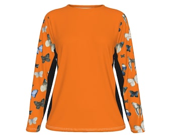 May include: Orange long-sleeve shirt with black sleeves and a butterfly pattern. The butterflies are in shades of blue, white, and brown.