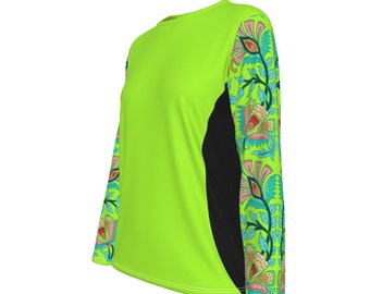 May include: A lime green long-sleeved shirt with black panels on the sides and a floral pattern on the sleeves. The floral pattern is in shades of pink, blue, green, and yellow.