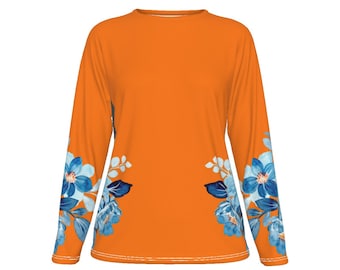 May include: Orange long-sleeved shirt with a floral pattern on the sleeves. The flowers are blue, white, and green.