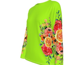 May include: A bright green long-sleeved shirt with a floral print on the right sleeve. The flowers are red, orange, yellow, and pink.