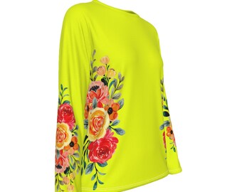 May include: A bright yellow long-sleeved shirt with a floral print on the left sleeve. The flowers are red, orange, yellow, and pink.