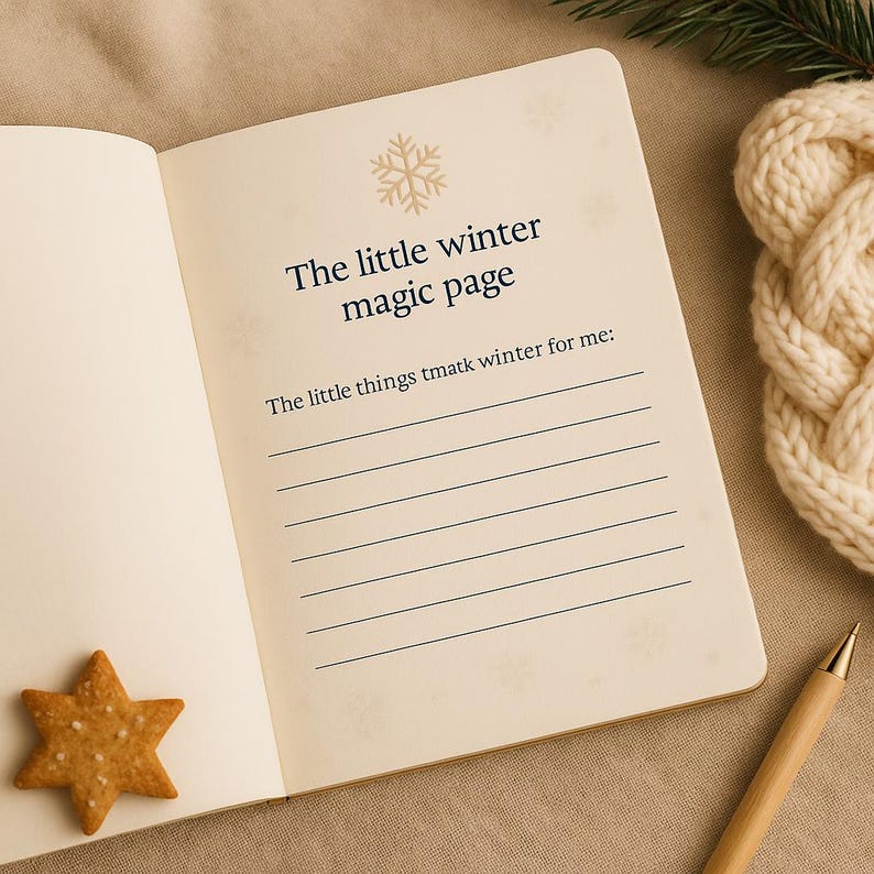 May include: Open journal with the text "The little winter magic page" and lined pages. A star-shaped biscuit and a pen are on the table. A knitted item and a sprig of greenery are in the background.