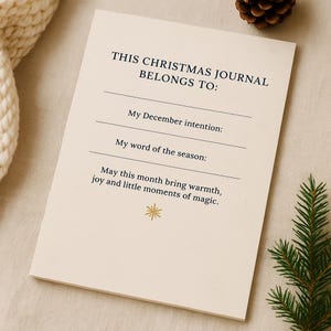 May include: A cream-coloured Christmas journal with the text "THIS CHRISTMAS JOURNAL BELONGS TO:" and prompts for December intentions and a seasonal word. A gold star graphic is at the bottom.