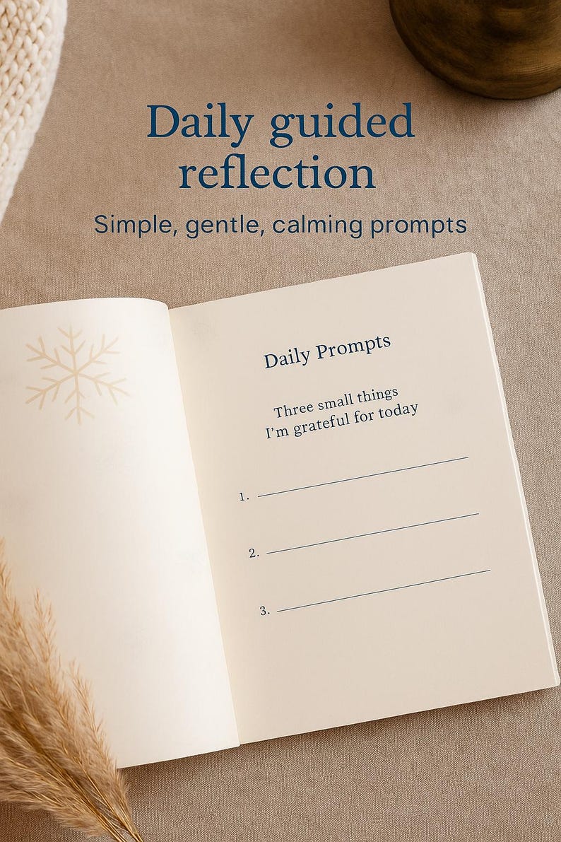 May include: An open journal with the text "Daily guided reflection" and "Daily Prompts". The journal prompts the user to list three things they are grateful for. A snowflake design is in the upper left corner.