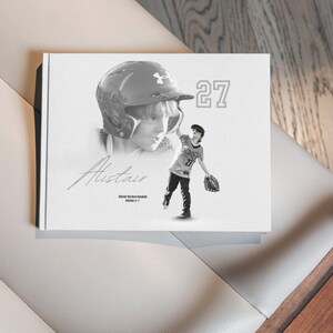 May include: A black and white baseball-themed photo book featuring a portrait of a young baseball player wearing a helmet. The name "Alistair" is written in cursive, with the number "27" displayed prominently. The image captures a dynamic action shot of the player.