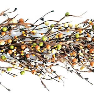 May include: A decorative garland with a variety of small, colourful berries in shades of green, orange, yellow, and white. The berries are attached to brown, twig-like stems with small, brown leaves. Suitable for seasonal home decoration.