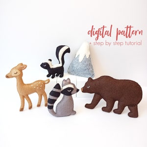 May include: A digital pattern for felt animal toys, including a deer, raccoon, skunk, and bear. The pattern also includes a mountain. The pattern is for a DIY project and includes a step-by-step tutorial.