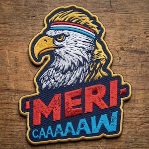 May include: An embroidered patch featuring a bald eagle with a yellow beak and a blonde mullet hairstyle, wearing a red, white, and blue headband. The text 'MERI-' is stitched in red and 'CAAAAAW' in light blue on a dark blue background.